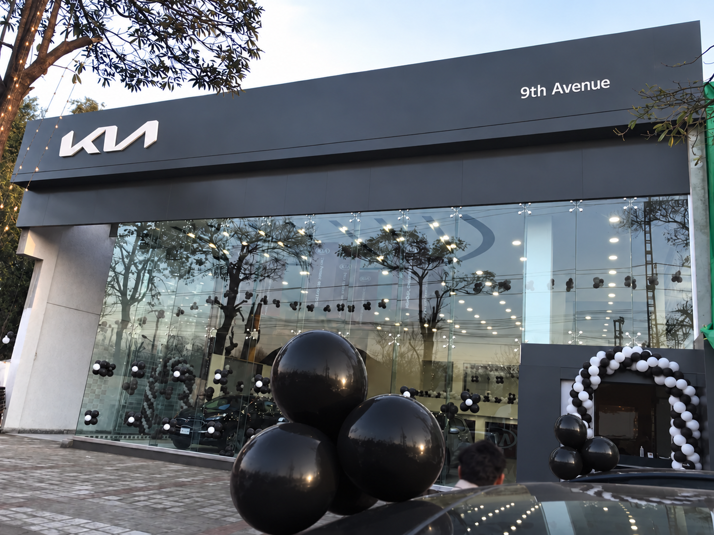 Kia Motors 9th Avenue exterior — archival photograph retouched with modern dark Kia branding